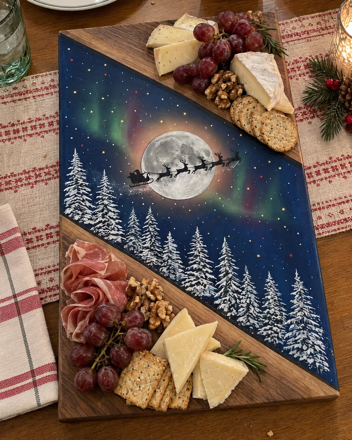 Sleigh and Moon Christmas board served with cheese, grapes, crackers and cured meats on a holiday table